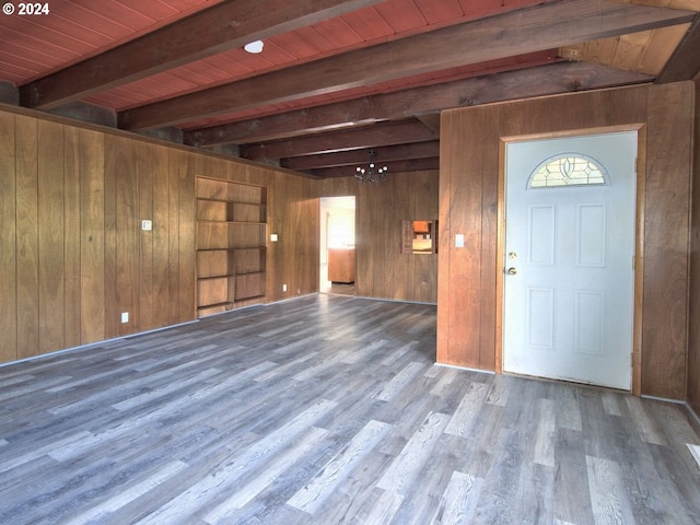 foyer entrance with hardwood / wood-style floors, wooden ceiling, wood walls, and beam ceiling