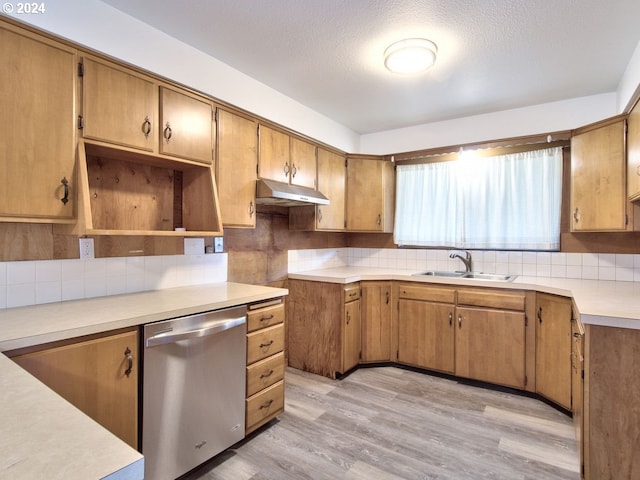 kitchen featuring sink, a textured ceiling, dishwasher, light wood-type flooring, and decorative backsplash