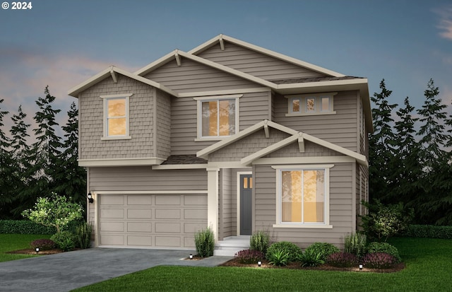 craftsman-style home featuring a garage and a yard