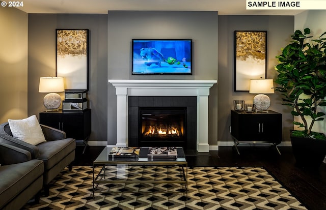 sitting room with a fireplace and dark hardwood / wood-style flooring