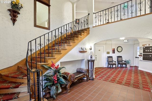 staircase featuring tile patterned flooring