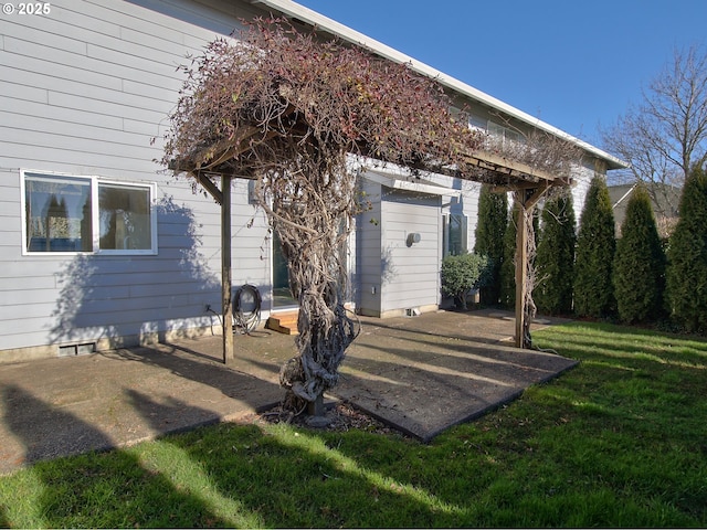 view of exterior entry with a yard and a patio area