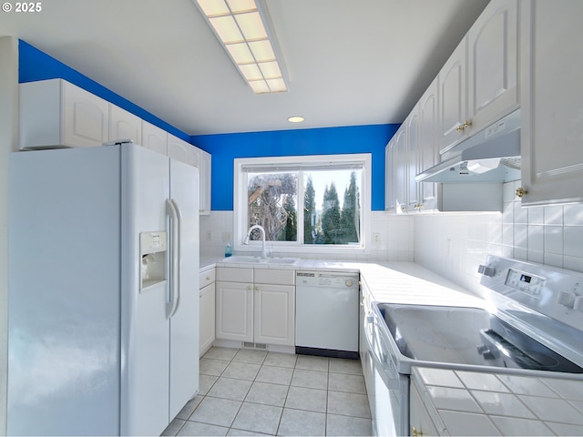 kitchen with white cabinetry, white appliances, sink, and backsplash