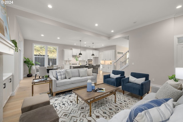 living room featuring light hardwood / wood-style floors and crown molding