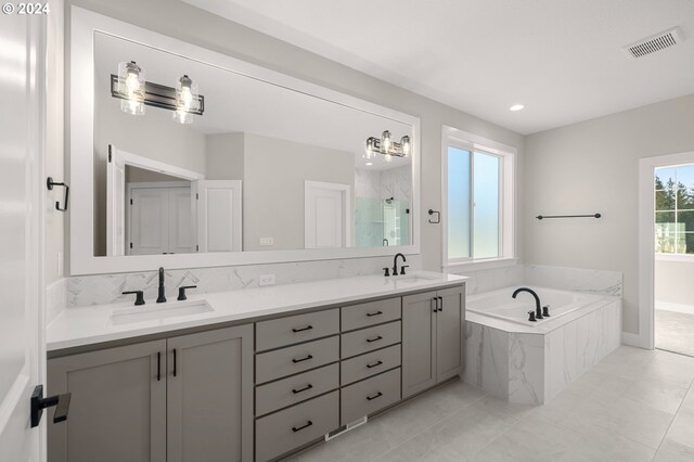 bathroom featuring vanity, tile patterned floors, and separate shower and tub