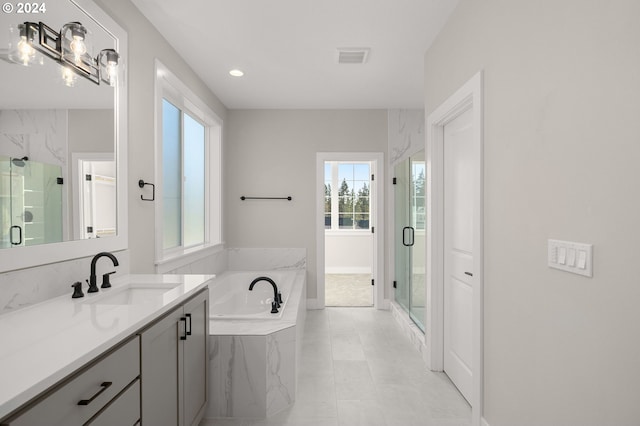 bathroom with tile patterned floors, vanity, and plus walk in shower