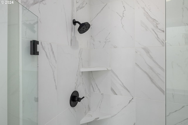 interior details with a tile shower