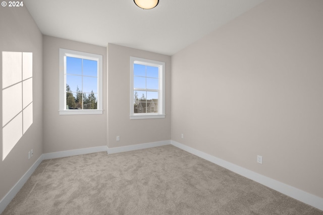 empty room featuring light colored carpet