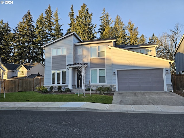 view of front of property with a front yard and a garage