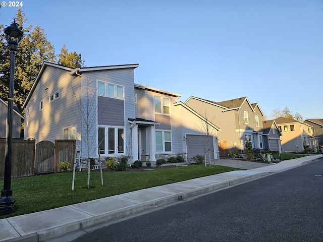 contemporary house featuring a garage and a front lawn