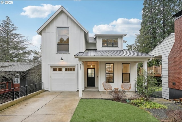 modern inspired farmhouse with covered porch and a garage