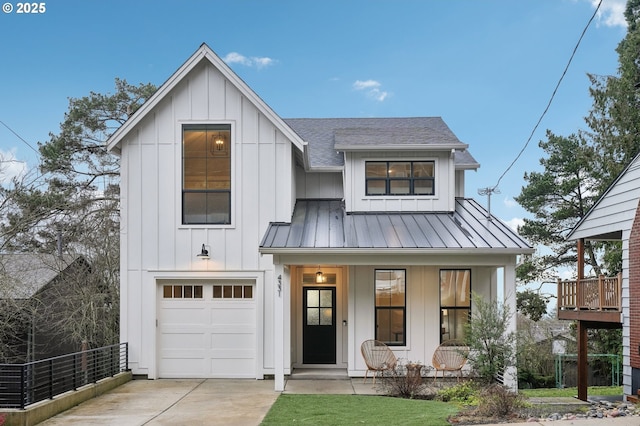 modern farmhouse featuring a porch and a garage