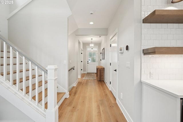 hallway with hardwood / wood-style flooring