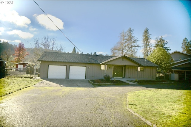 ranch-style home featuring a garage and a front yard