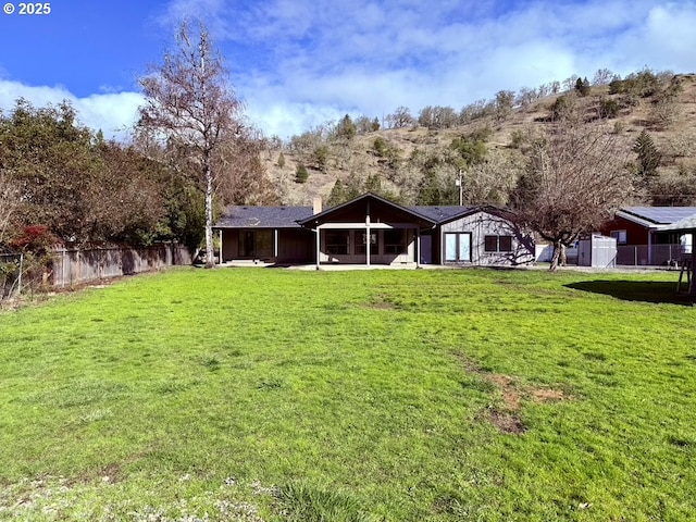 rear view of property with a lawn