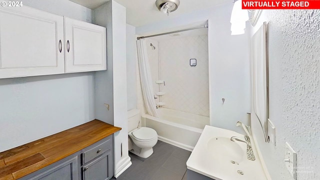 full bathroom featuring tile patterned floors, vanity, toilet, and shower / bath combo with shower curtain