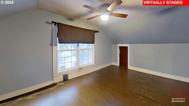 bonus room with ceiling fan, dark wood-type flooring, and vaulted ceiling