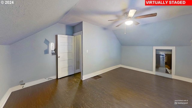 bonus room with vaulted ceiling, ceiling fan, a textured ceiling, and dark hardwood / wood-style floors