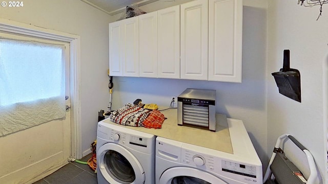 laundry area featuring washing machine and clothes dryer, cabinets, and ornamental molding