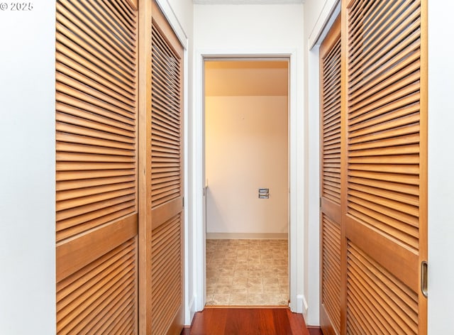 corridor with dark wood-type flooring