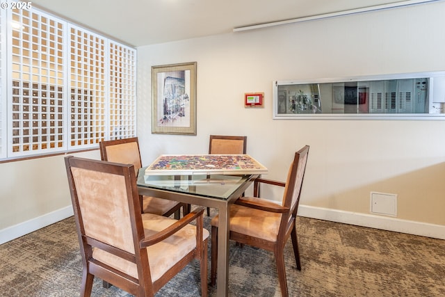 dining room featuring carpet flooring and baseboards