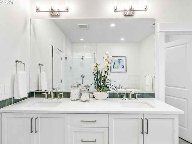 bathroom with a shower with door and vanity