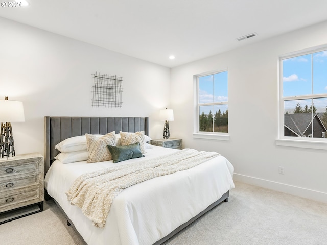 carpeted bedroom featuring multiple windows