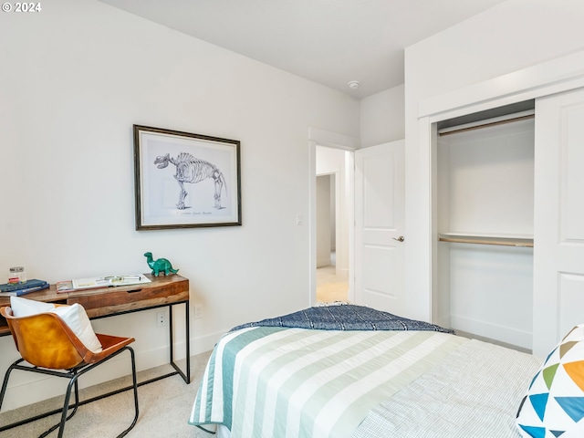 bedroom featuring light carpet and a closet