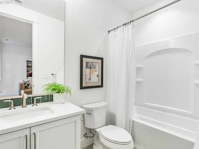 full bathroom featuring toilet, shower / tub combo with curtain, and vanity