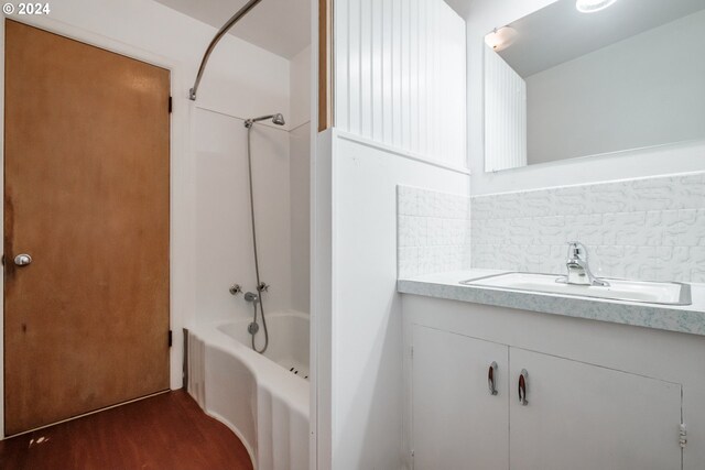 bathroom featuring vanity and tasteful backsplash