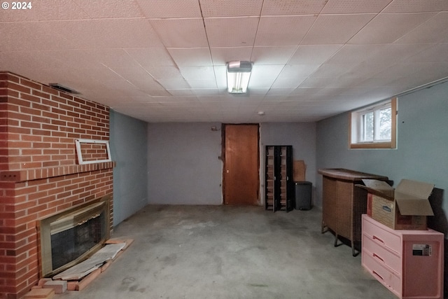 basement with light colored carpet and a fireplace