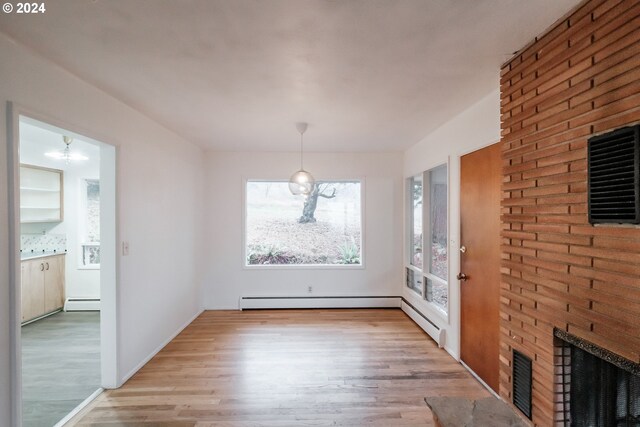 kitchen featuring light brown cabinets, sink, light hardwood / wood-style floors, washer / dryer, and stainless steel appliances