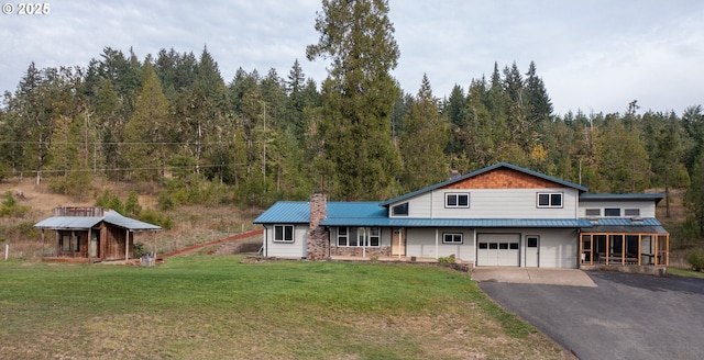 37075 Camp Creek Rd, Springfield, OR 97478 - view of front of home featuring a chimney, an attached garage, driveway, a wooded view, and a front lawn