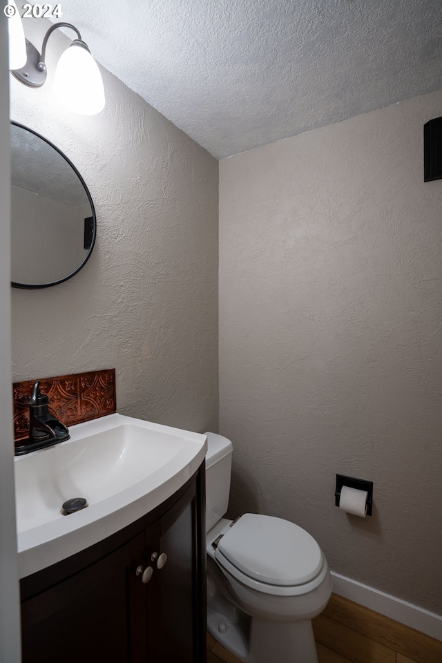 37075 Camp Creek Rd, Springfield, OR 97478 - bathroom featuring vanity, wood finished floors, and a textured ceiling