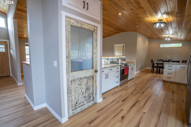 interior space with light hardwood / wood-style floors, wood ceiling, and vaulted ceiling