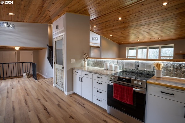 37075 Camp Creek Rd, Springfield, OR 97478 - kitchen with stainless steel electric range, wood ceiling, recessed lighting, white cabinets, and light wood finished floors