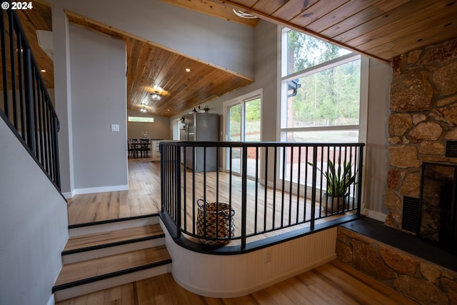 37075 Camp Creek Rd, Springfield, OR 97478 - stairway featuring wood ceiling, vaulted ceiling, wood-type flooring, and a stone fireplace
