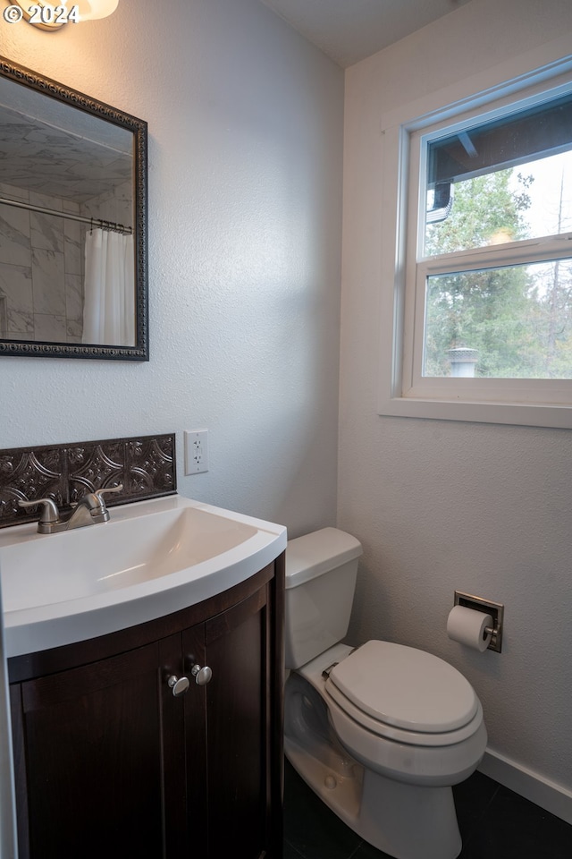 bathroom with vanity, toilet, and tile patterned floors