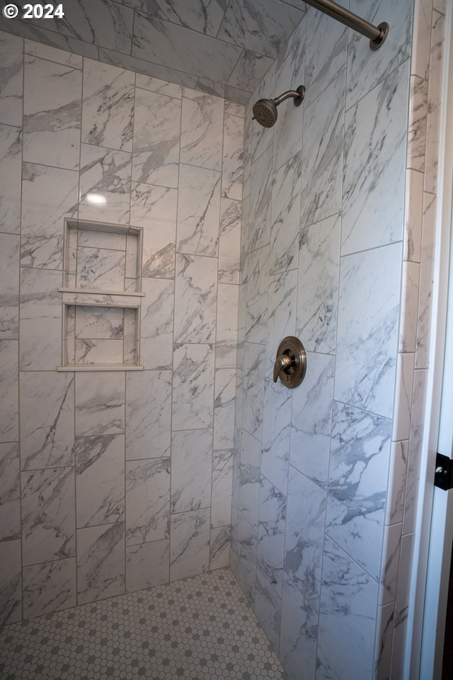 bathroom with tiled shower