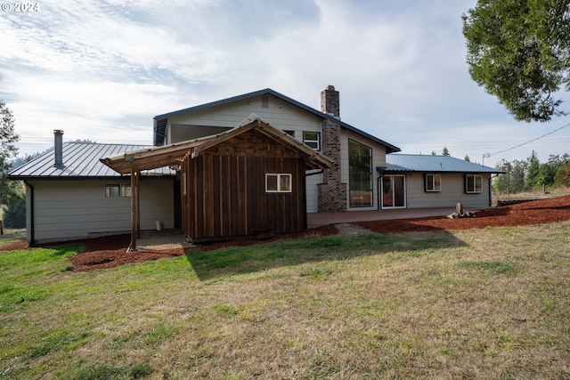 37075 Camp Creek Rd, Springfield, OR 97478 - back of house with a chimney, a patio area, a yard, a metal roof, and a standing seam roof