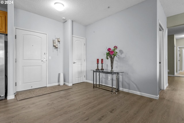 foyer featuring hardwood / wood-style flooring and a textured ceiling