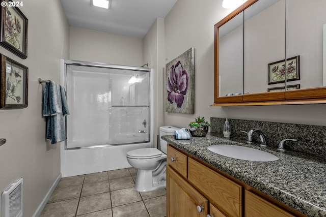 full bathroom with enclosed tub / shower combo, vanity, toilet, and tile patterned flooring