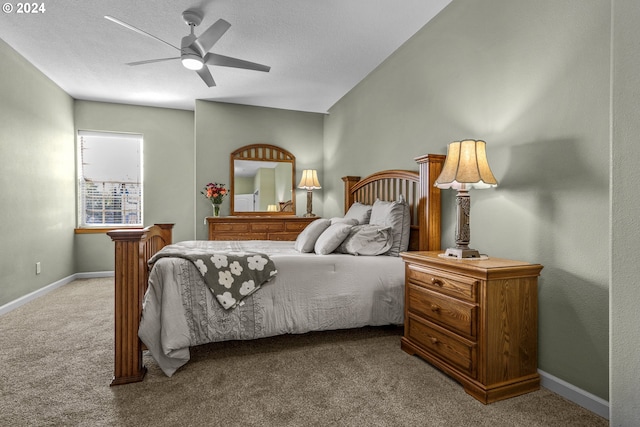 bedroom with ceiling fan, light carpet, and a textured ceiling