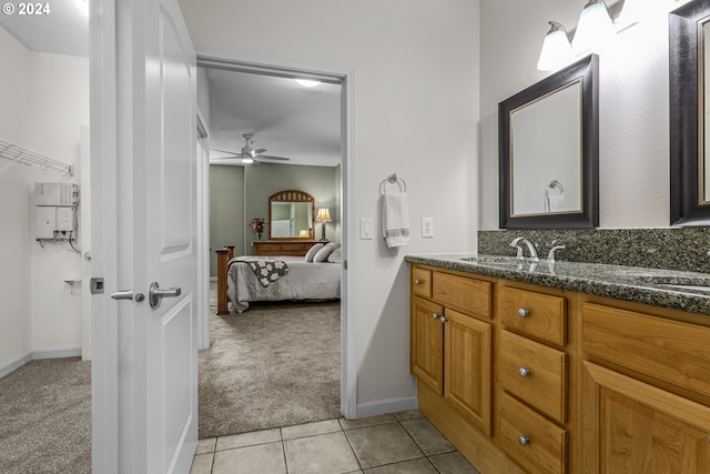 bathroom with tile patterned flooring, vanity, and ceiling fan