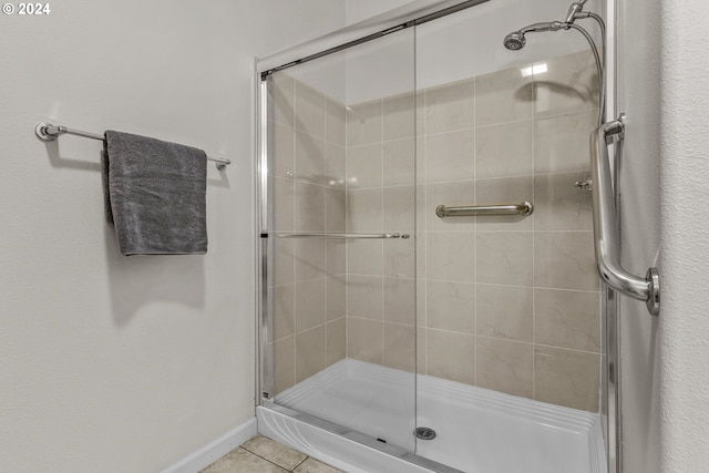 bathroom with tile patterned flooring and walk in shower