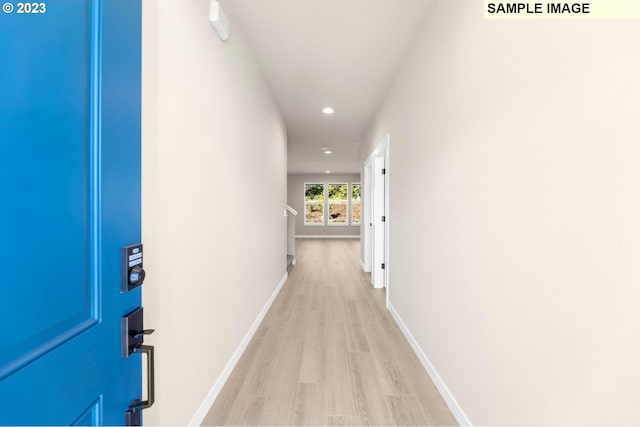 hallway with light hardwood / wood-style floors