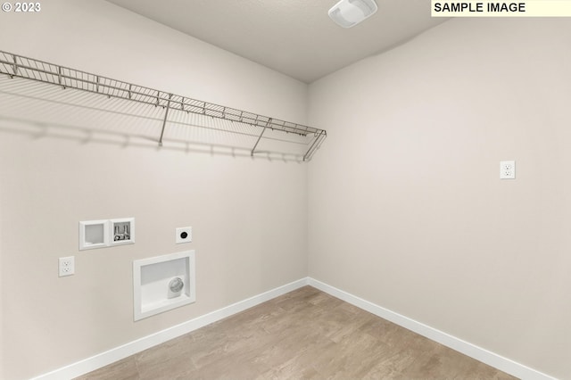 clothes washing area featuring hookup for a washing machine, wood-type flooring, and hookup for an electric dryer