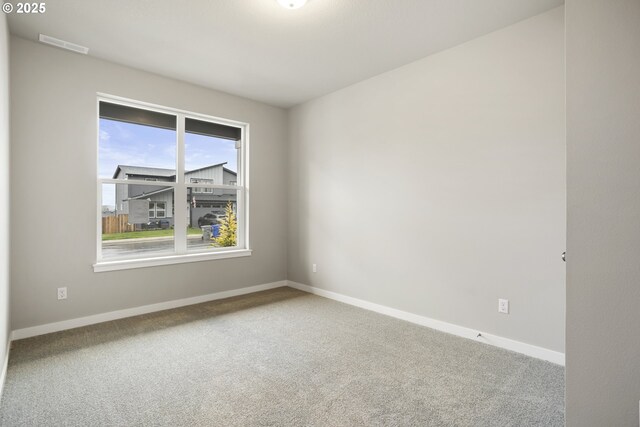 kitchen with appliances with stainless steel finishes, a kitchen island with sink, white cabinetry, and a tiled fireplace