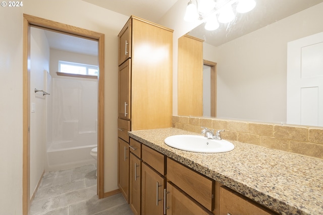 bathroom featuring backsplash, tile patterned flooring, vanity, and toilet