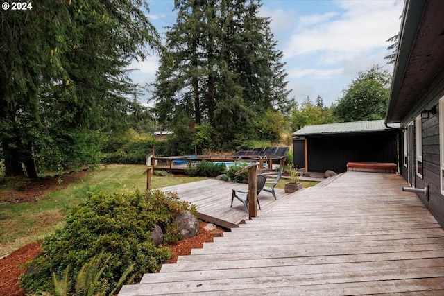 wooden deck featuring a swimming pool